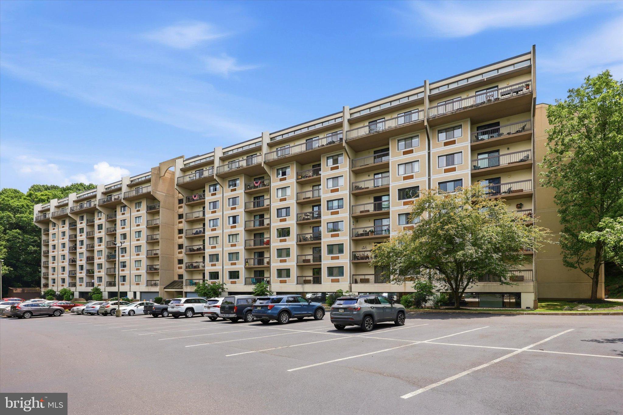 800 Avondale Road, Unit 2K Wallingford, PA 19086 - Photo 43 of 44 Modern apartment complex with greenery.