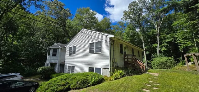 a view of house with a yard