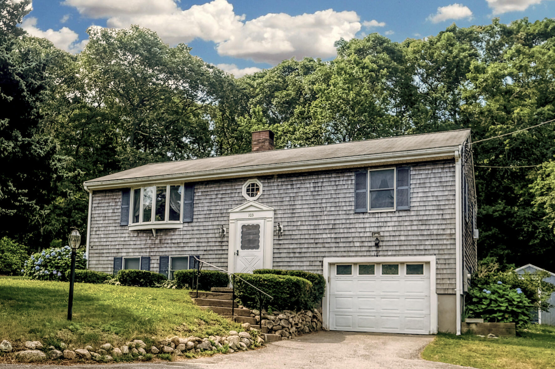 a front view of a house with garden