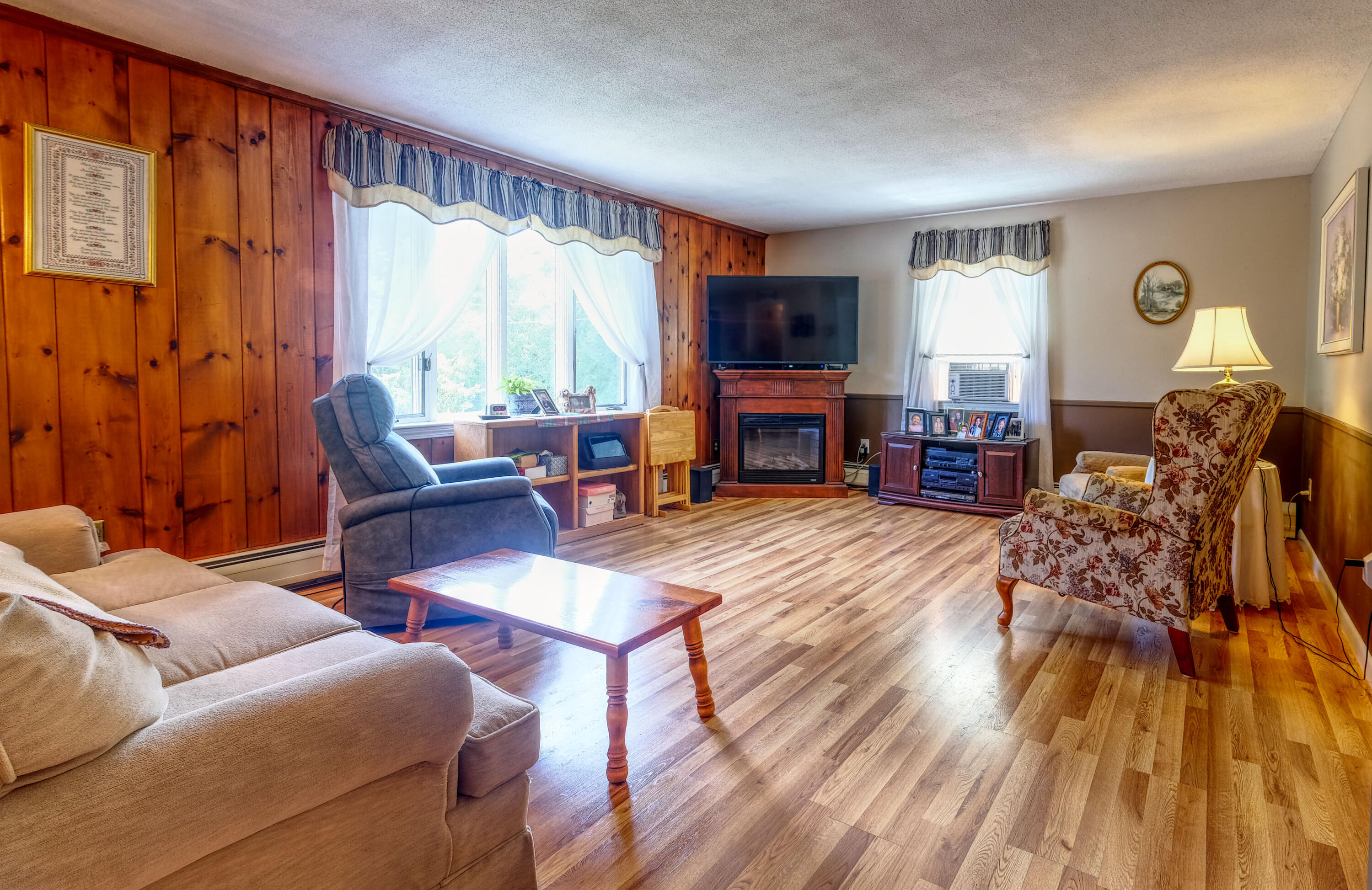 103 Moco Road West Barnstable, MA 02668 - Photo 14 of 47 a living room with furniture a fireplace and a flat screen tv