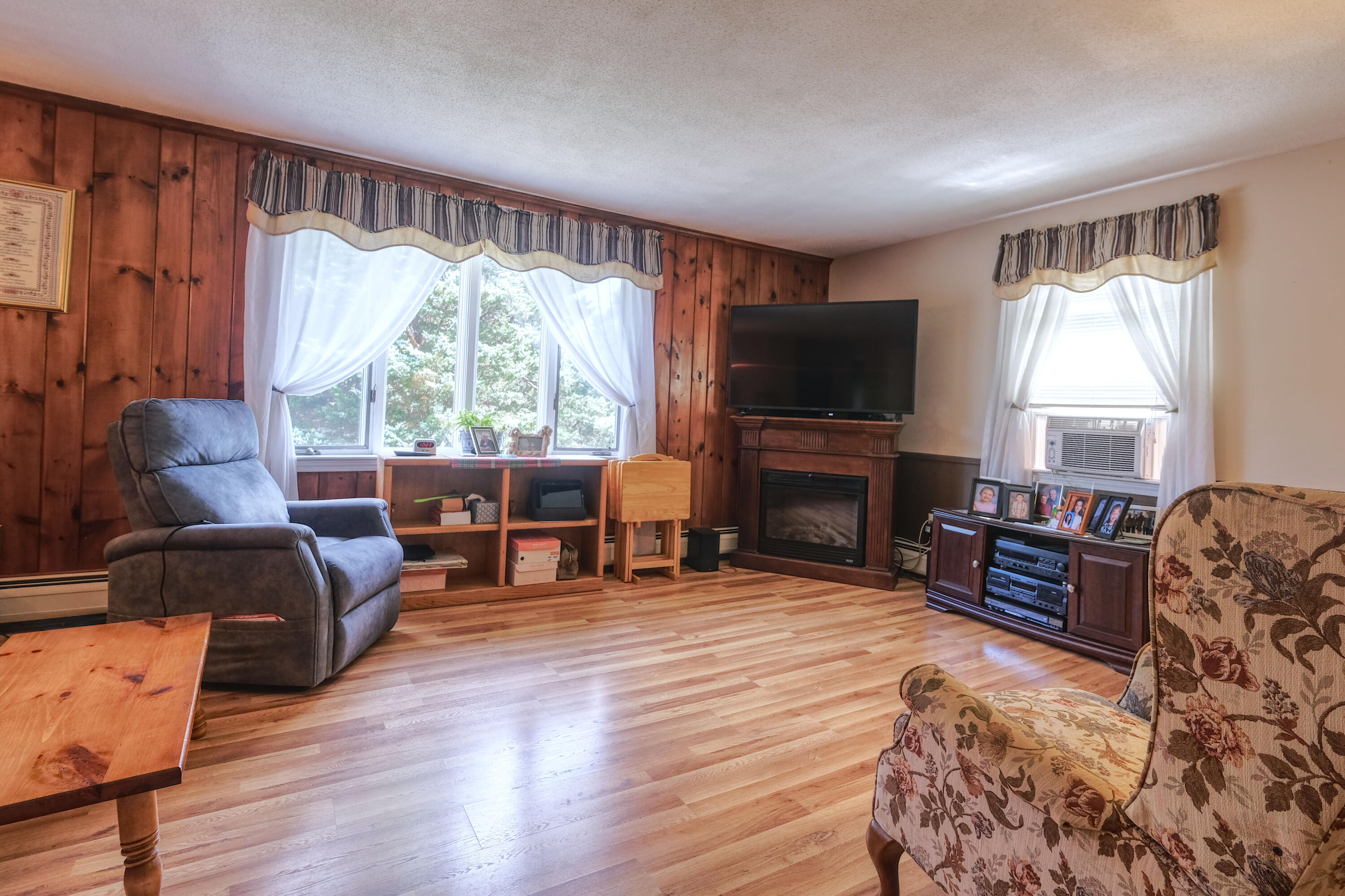 103 Moco Road West Barnstable, MA 02668 - Photo 17 of 47 a living room with furniture a flat screen tv and a fireplace