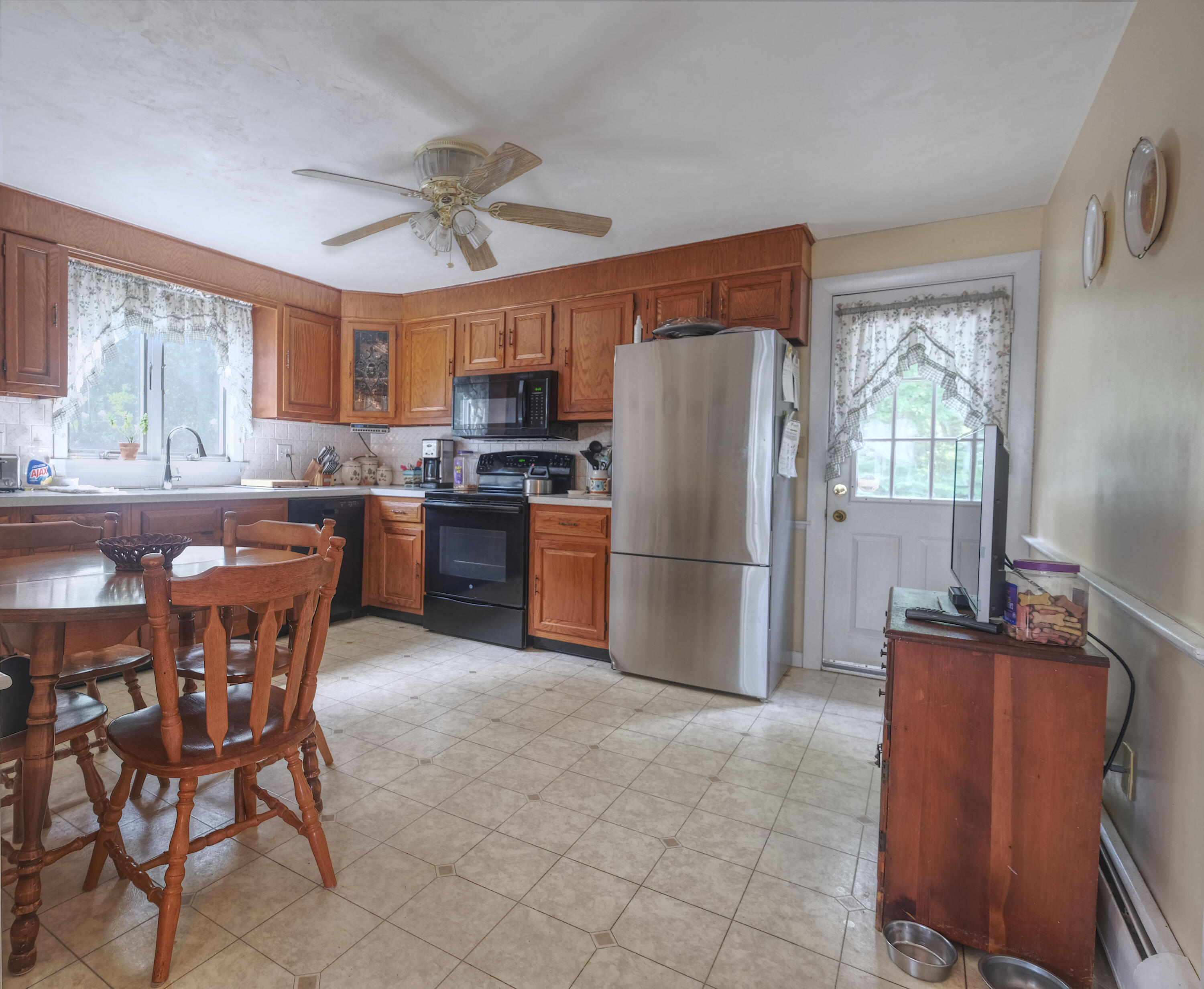 103 Moco Road West Barnstable, MA 02668 - Photo 23 of 47 a kitchen with stainless steel appliances granite countertop a refrigerator a sink a stove a dining table and chairs