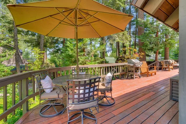 a view of a balcony with wooden floor and outdoor seating