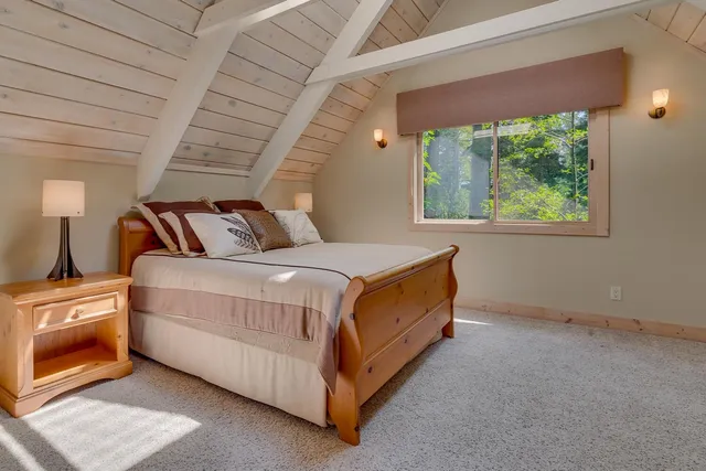 a bed room with a bed and a chair