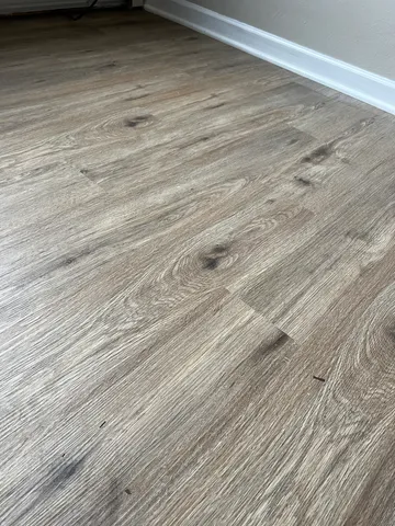 a view of a room with wooden floor