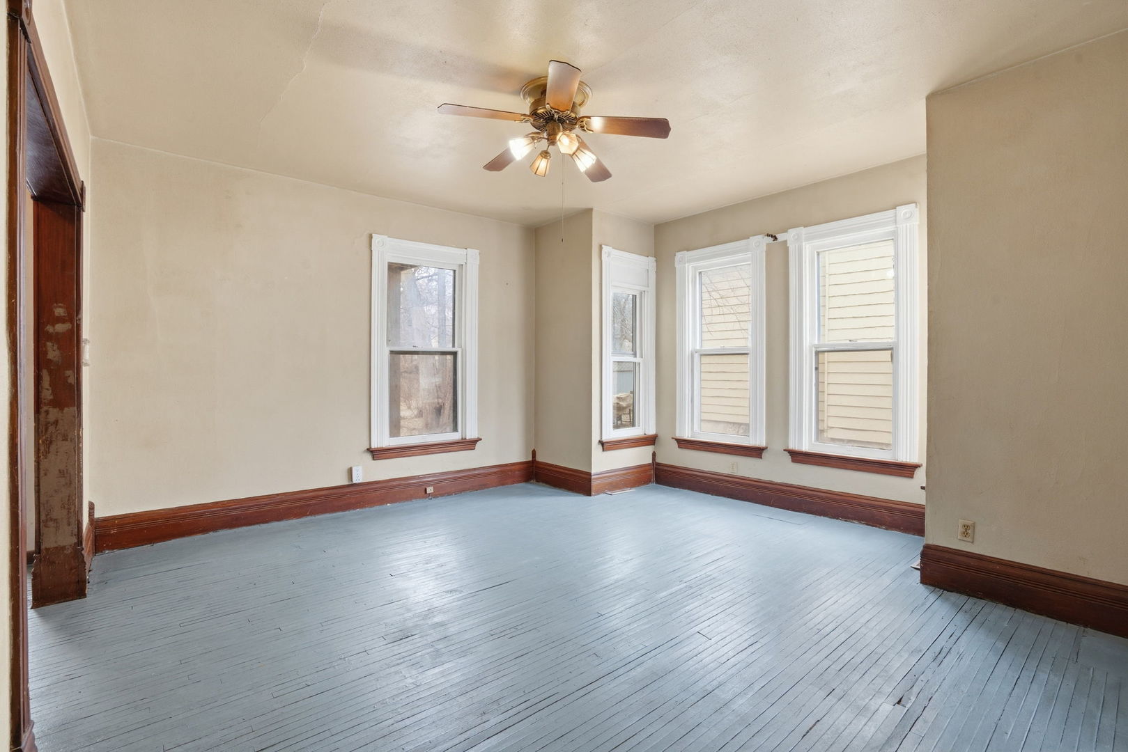 903 44th Street Rock Island, IL 61201 - Photo 5 of 28 a view of an empty room with wooden floor and a window