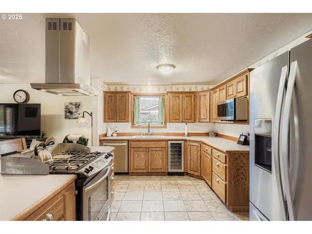 a kitchen with a stove sink and refrigerator