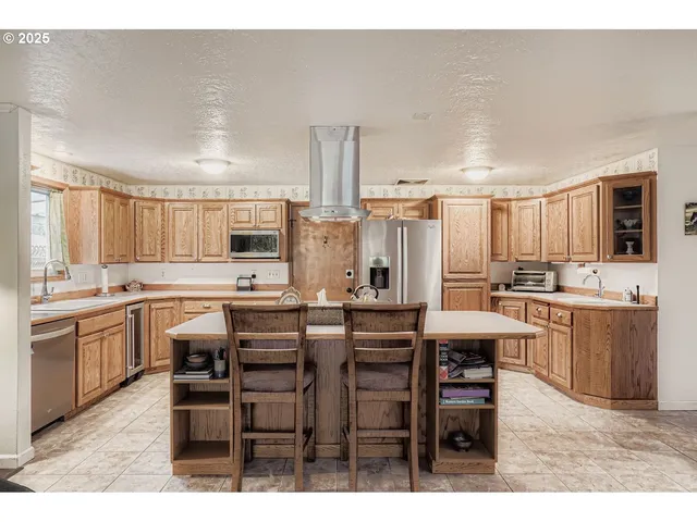 a large kitchen with a table and chairs
