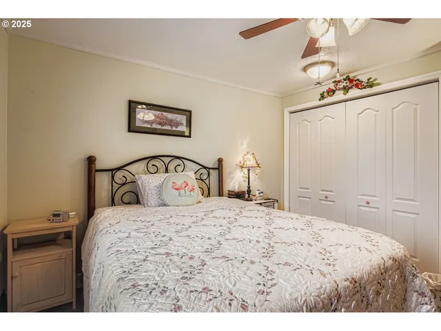 a bedroom with a large bed and a chandelier