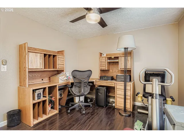 a living room with furniture a piano and a bookshelf