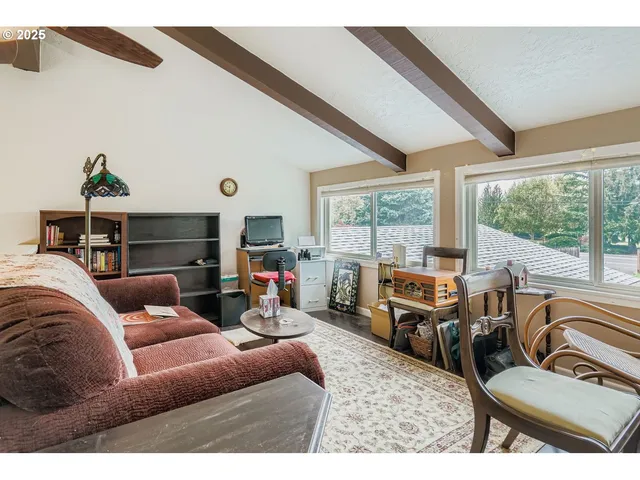 a living room with furniture and a floor to ceiling window