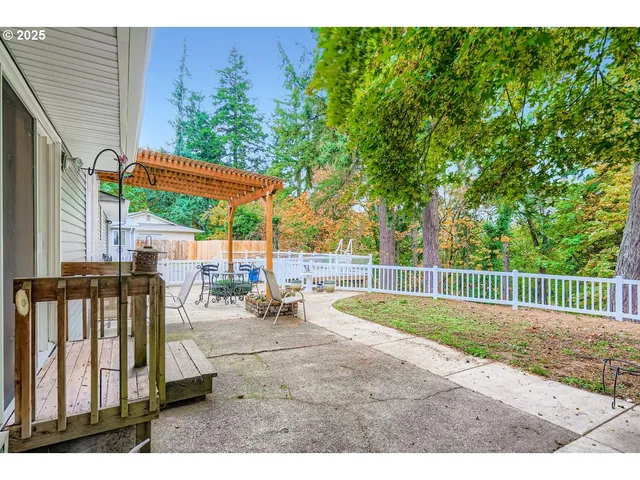 a view of a patio with a table and chairs under an umbrella