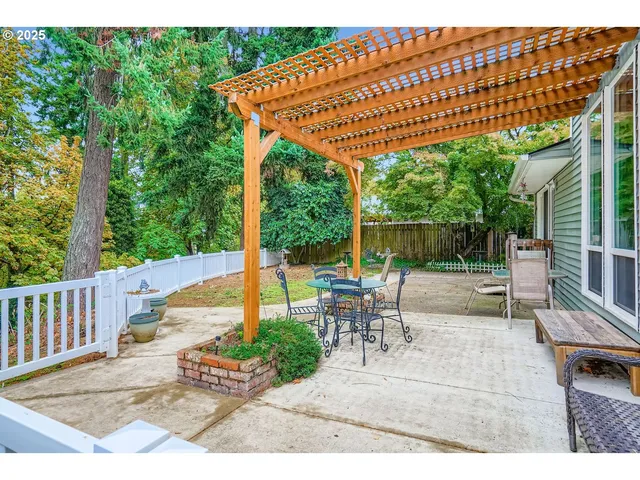 a view of a patio with a table and chairs