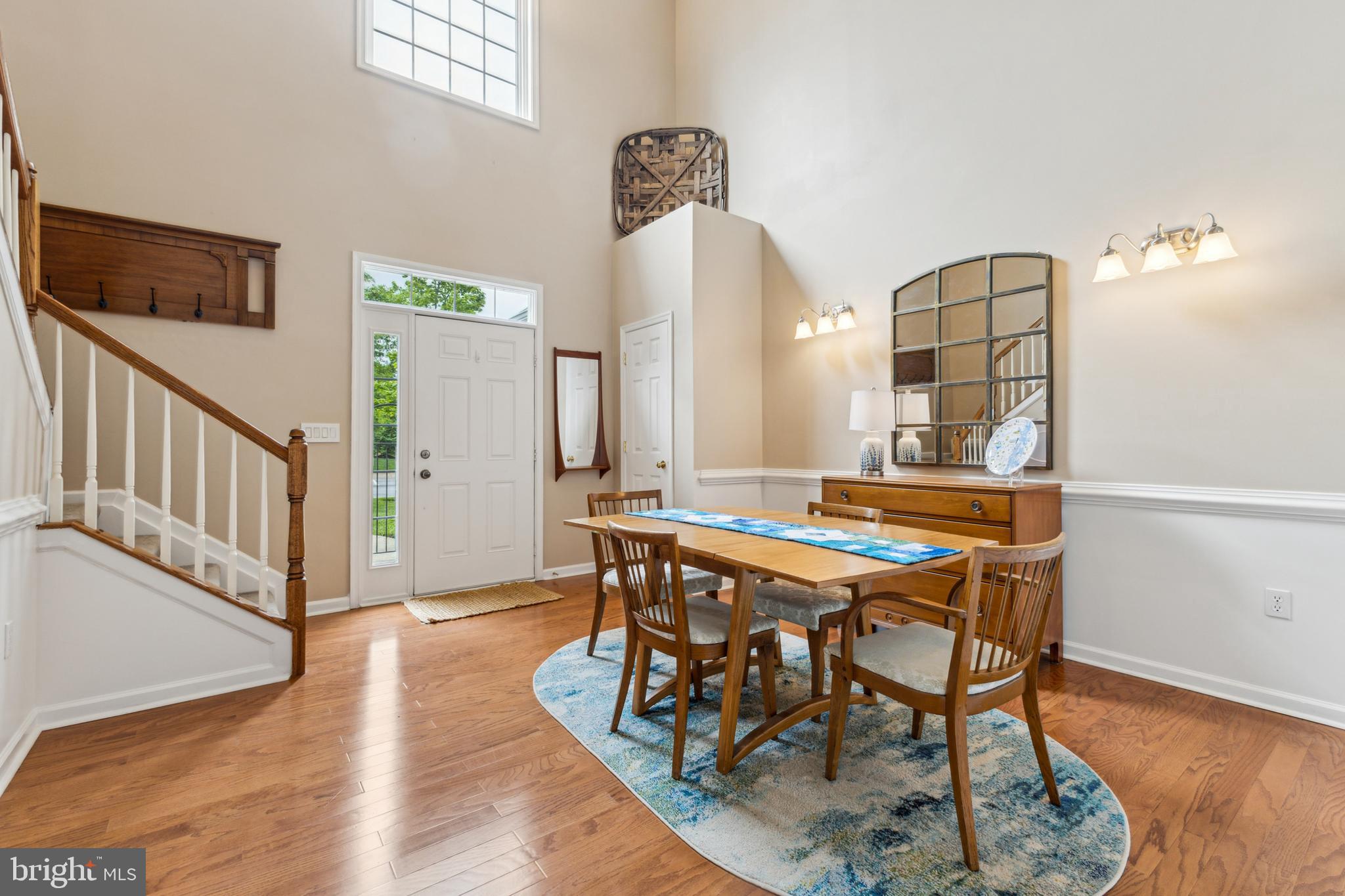 633 Ruxton Road, Unit 75 Solomons, MD 20629 - Photo 14 of 43 a dining room with wooden floor a chandelier a wooden table and chairs