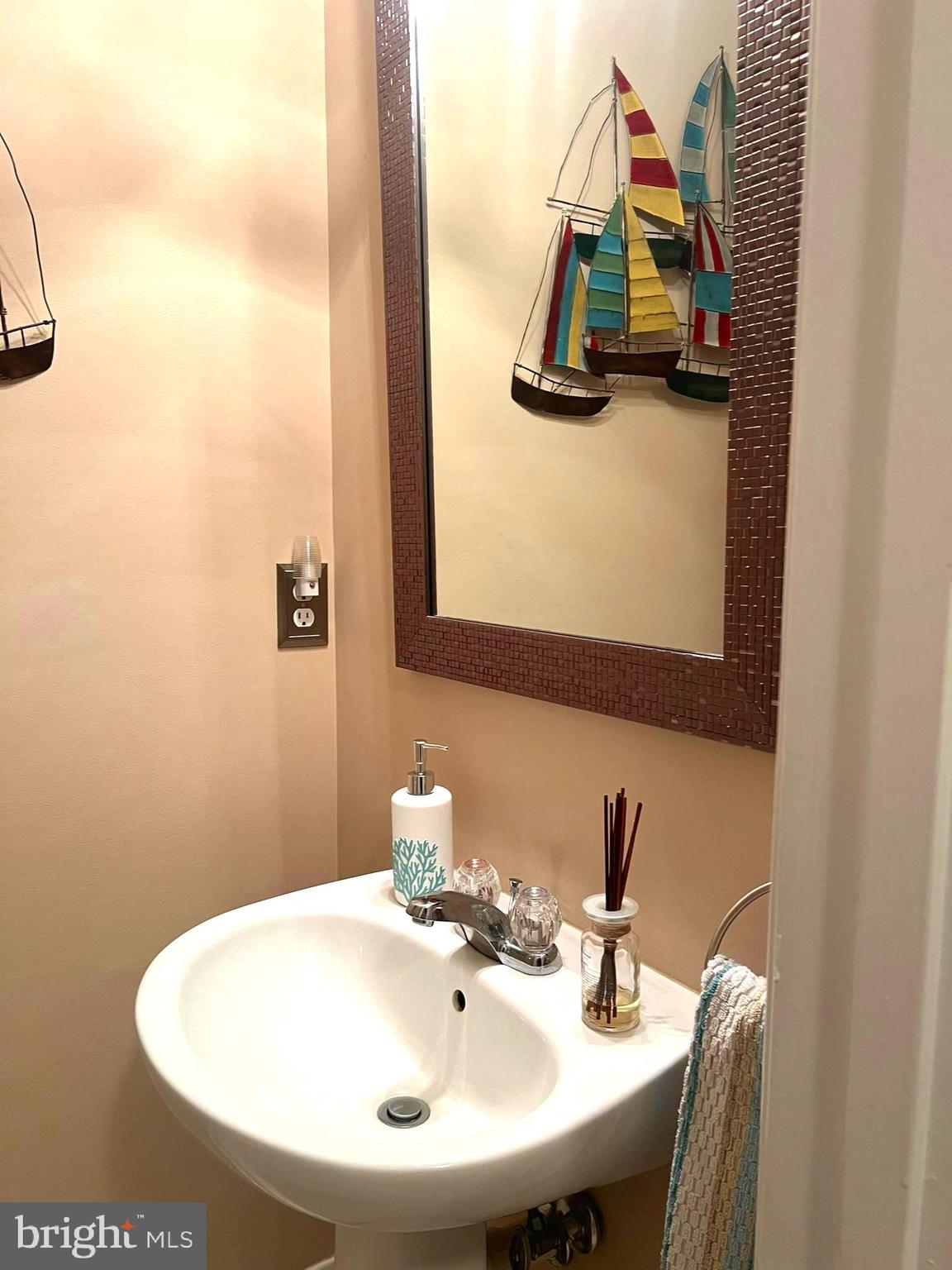 633 Ruxton Road, Unit 75 Solomons, MD 20629 - Photo 18 of 43 a bathroom with a sink and a mirror