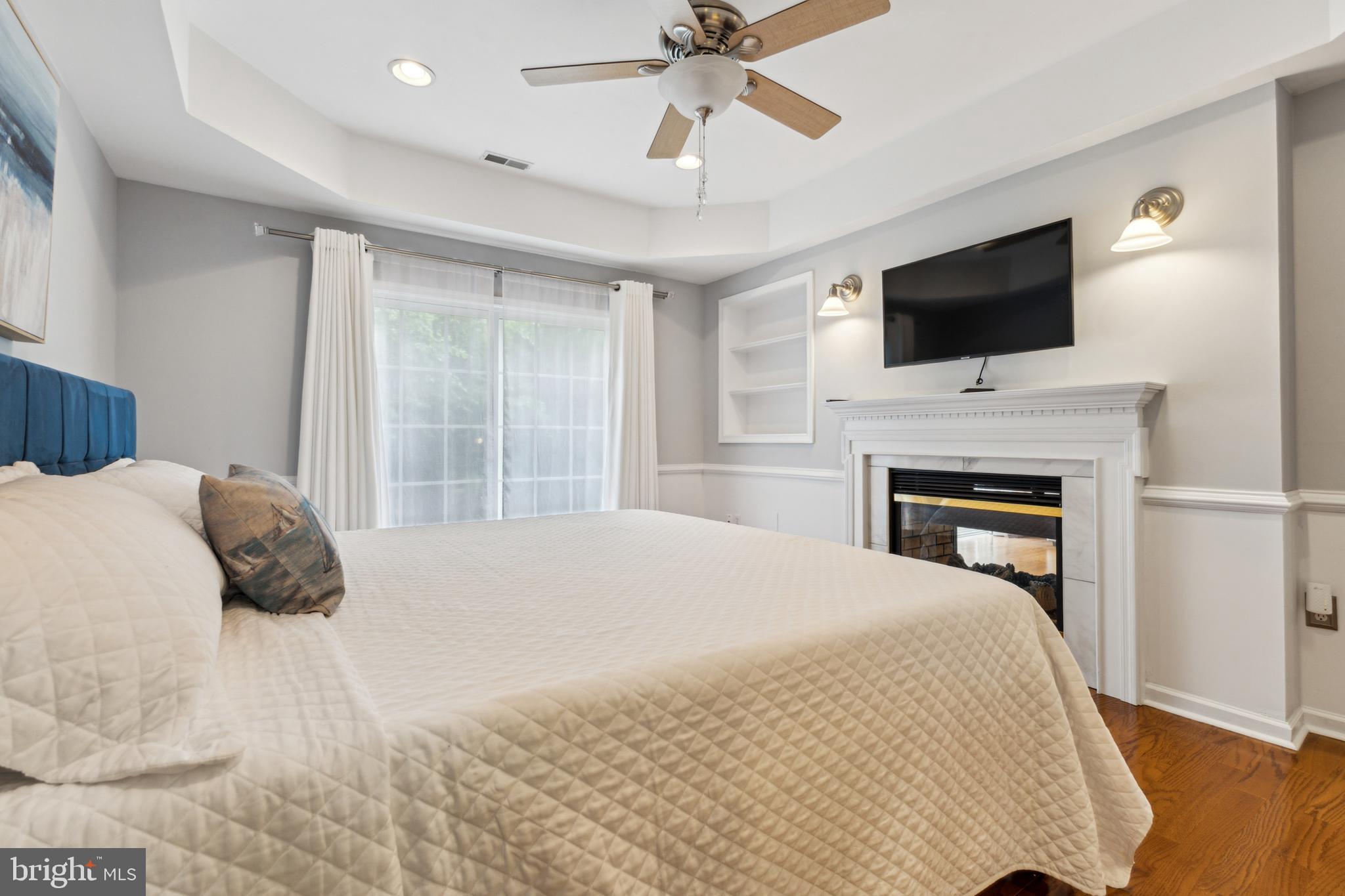 633 Ruxton Road, Unit 75 Solomons, MD 20629 - Photo 20 of 43 a bedroom with a bed and a flat screen tv