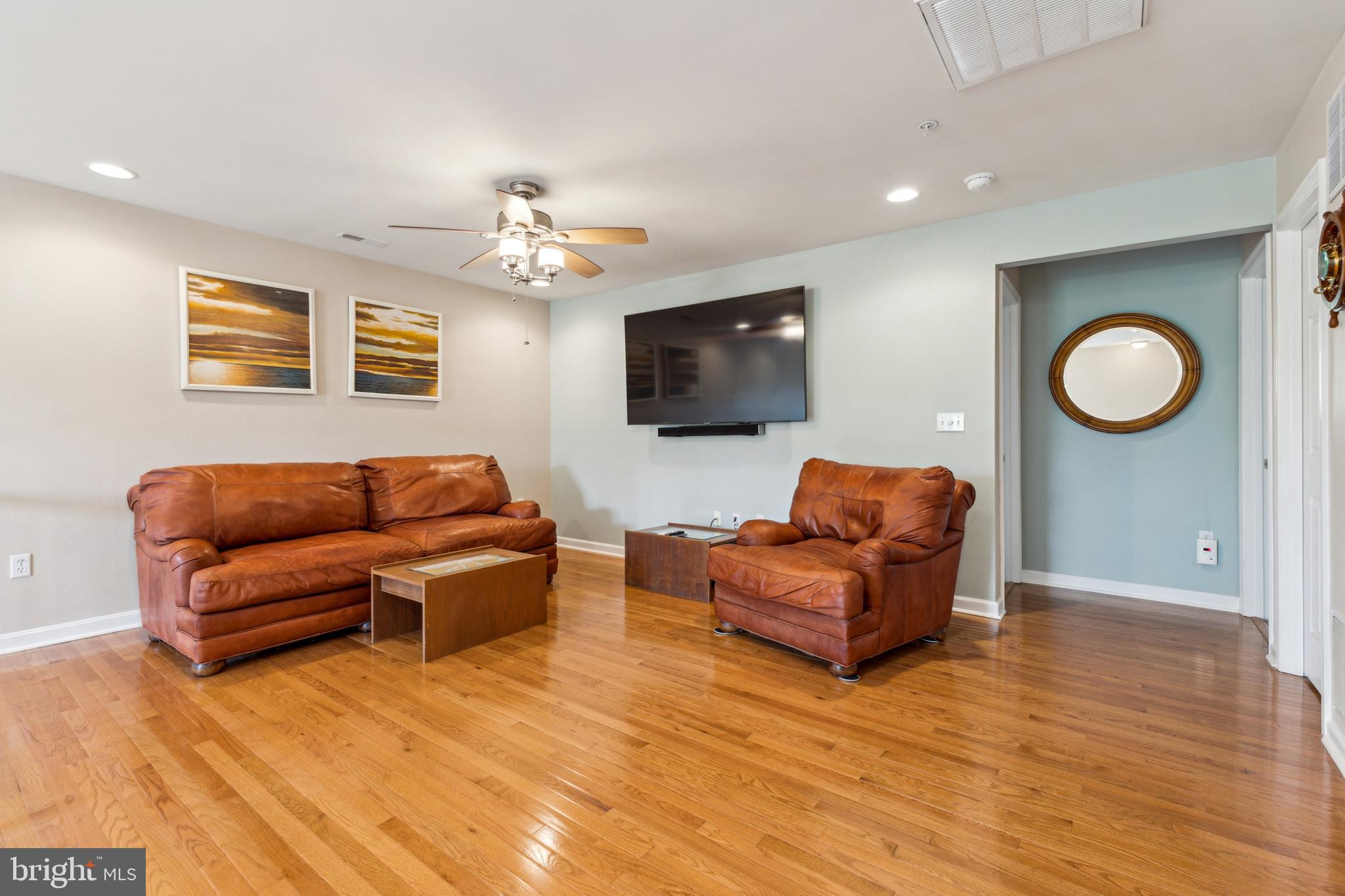 633 Ruxton Road, Unit 75 Solomons, MD 20629 - Photo 26 of 43 a living room with furniture and a flat screen tv