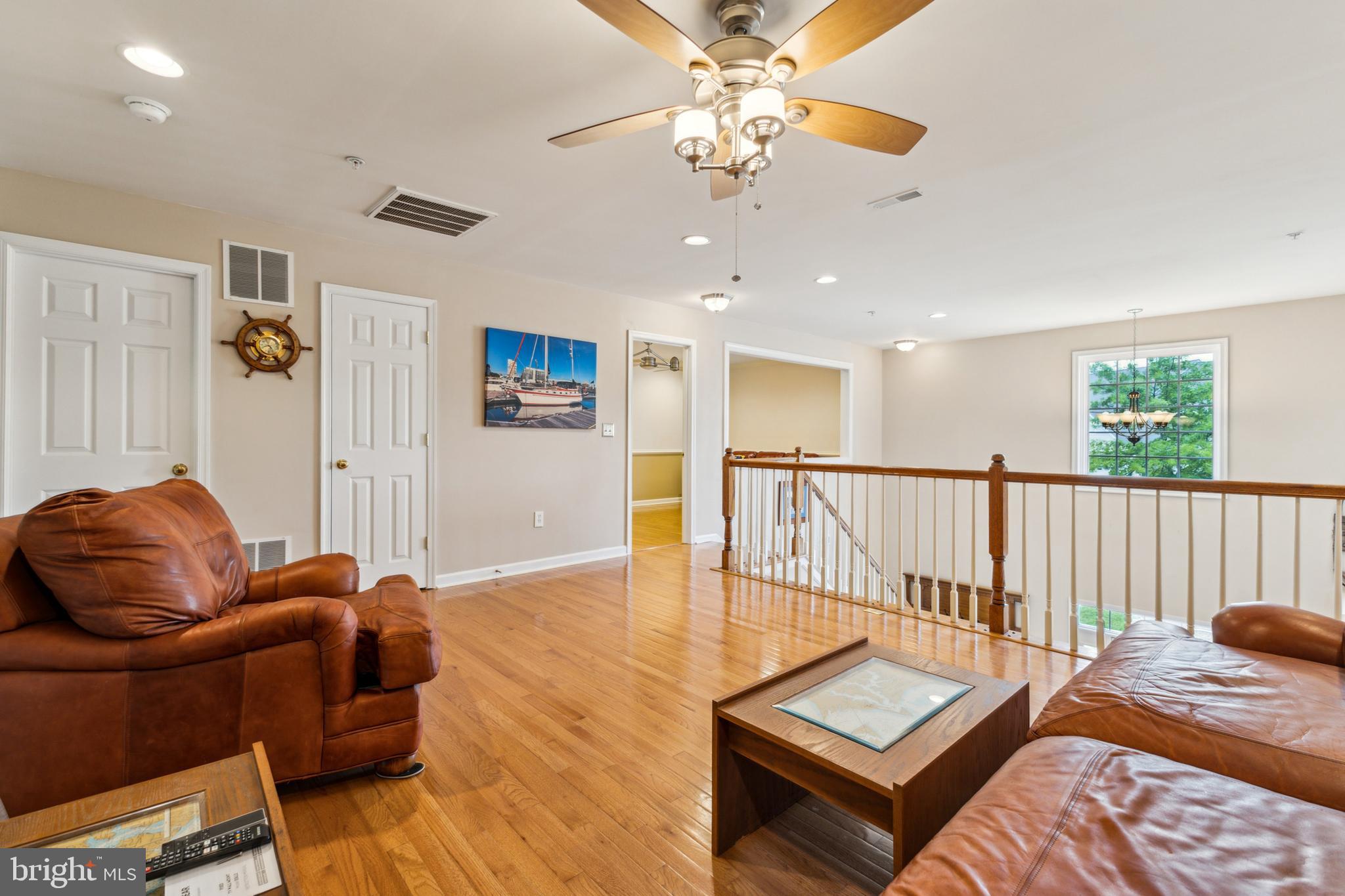 633 Ruxton Road, Unit 75 Solomons, MD 20629 - Photo 28 of 43 a living room with furniture and a wooden floor