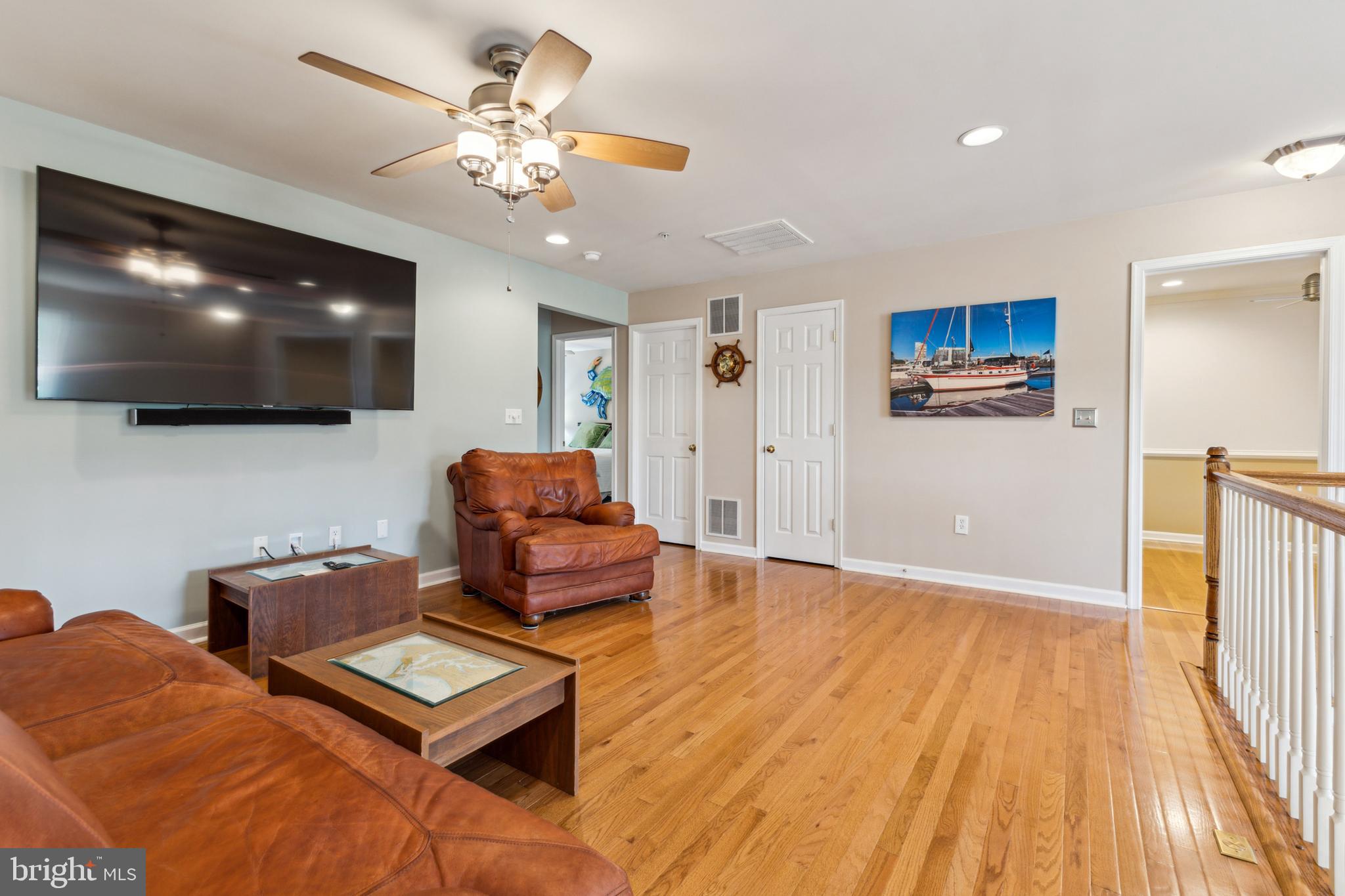 633 Ruxton Road, Unit 75 Solomons, MD 20629 - Photo 29 of 43 a living room with furniture and a flat screen tv