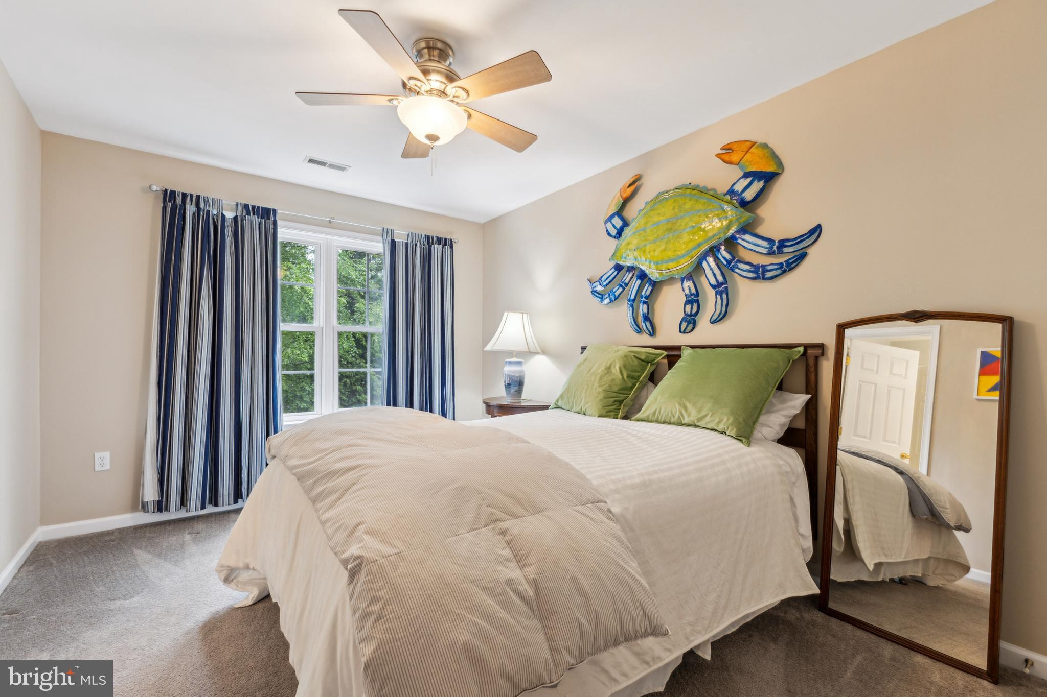 633 Ruxton Road, Unit 75 Solomons, MD 20629 - Photo 32 of 43 a bedroom with a bed and a window