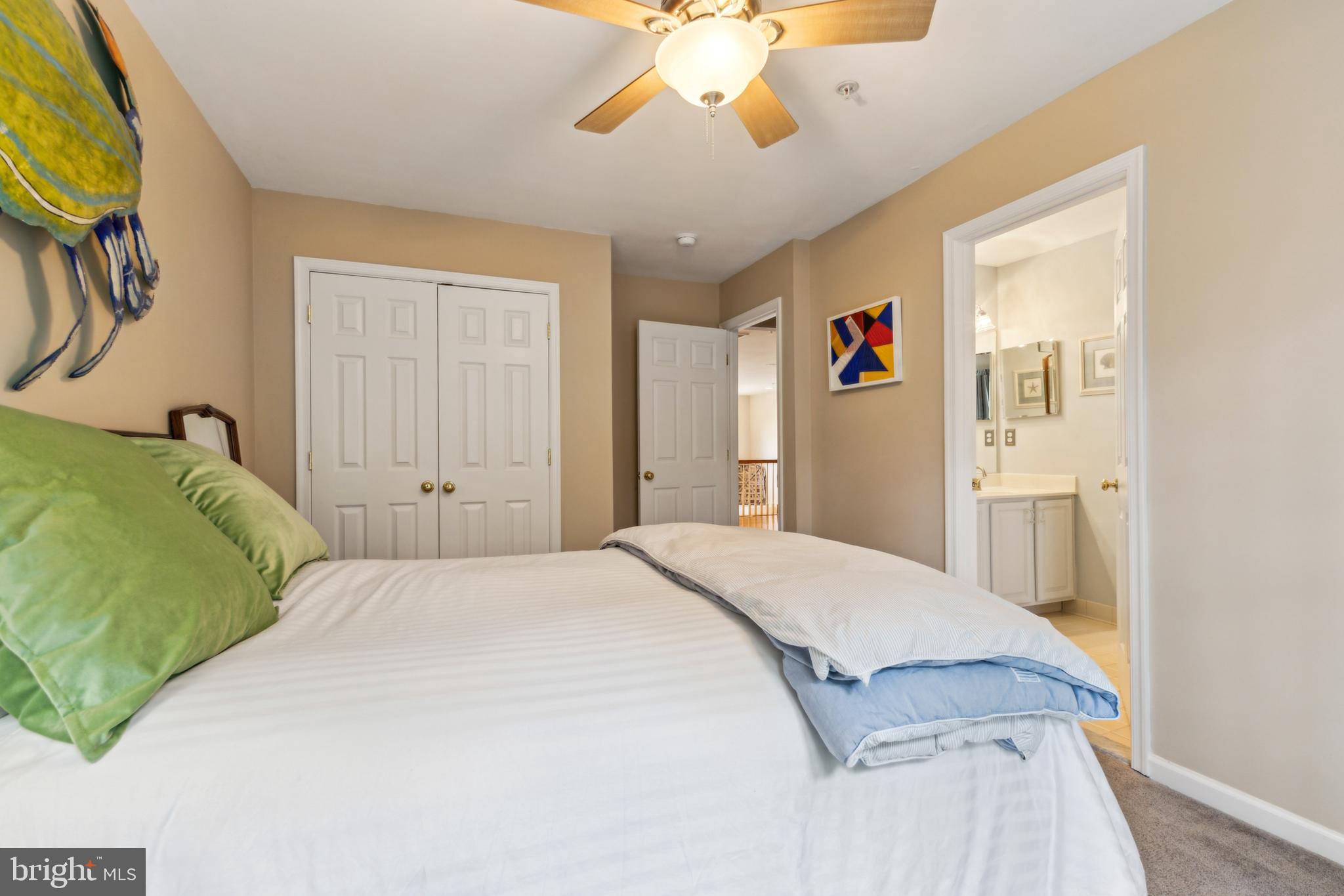 633 Ruxton Road, Unit 75 Solomons, MD 20629 - Photo 33 of 43 a spacious bedroom with a bed and a chandelier