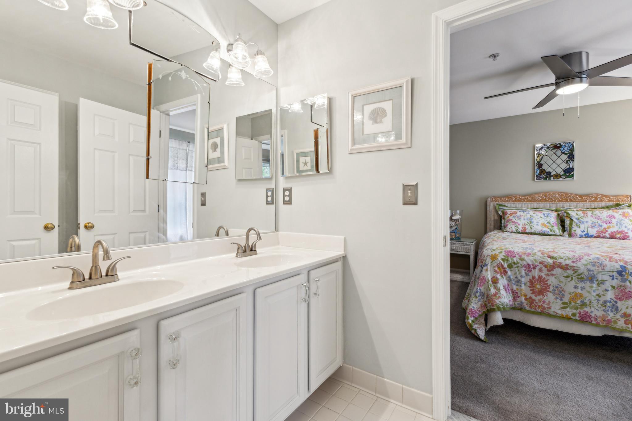 633 Ruxton Road, Unit 75 Solomons, MD 20629 - Photo 36 of 43 a en suite bathroom with a double vanity sink and a mirror