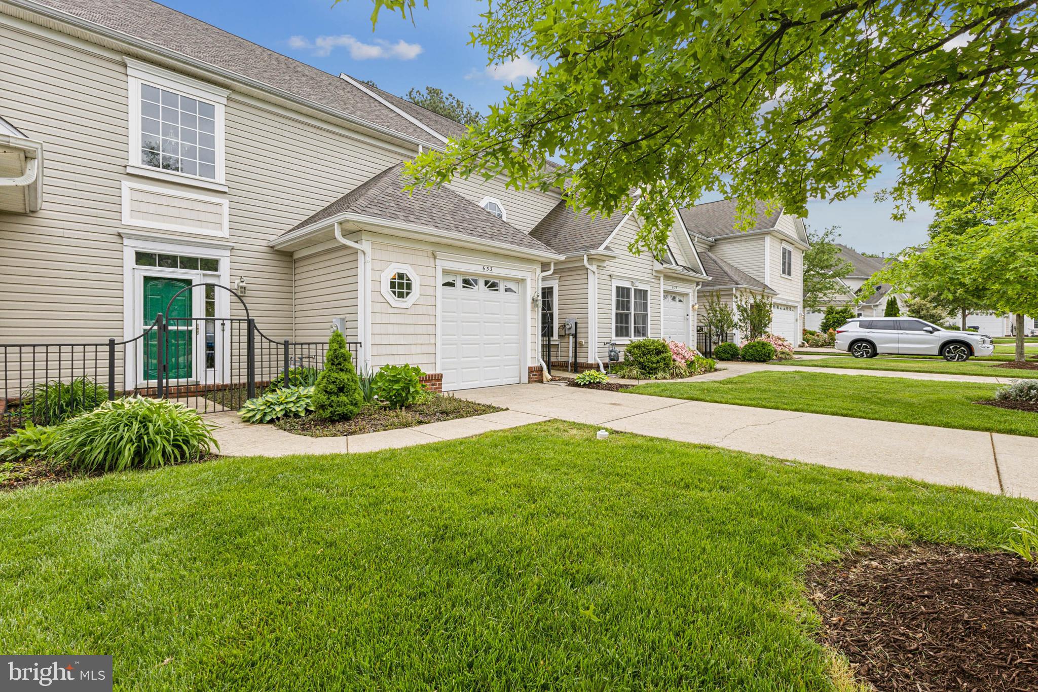 633 Ruxton Road, Unit 75 Solomons, MD 20629 - Photo 41 of 43 a front view of a house with a yard and potted plants