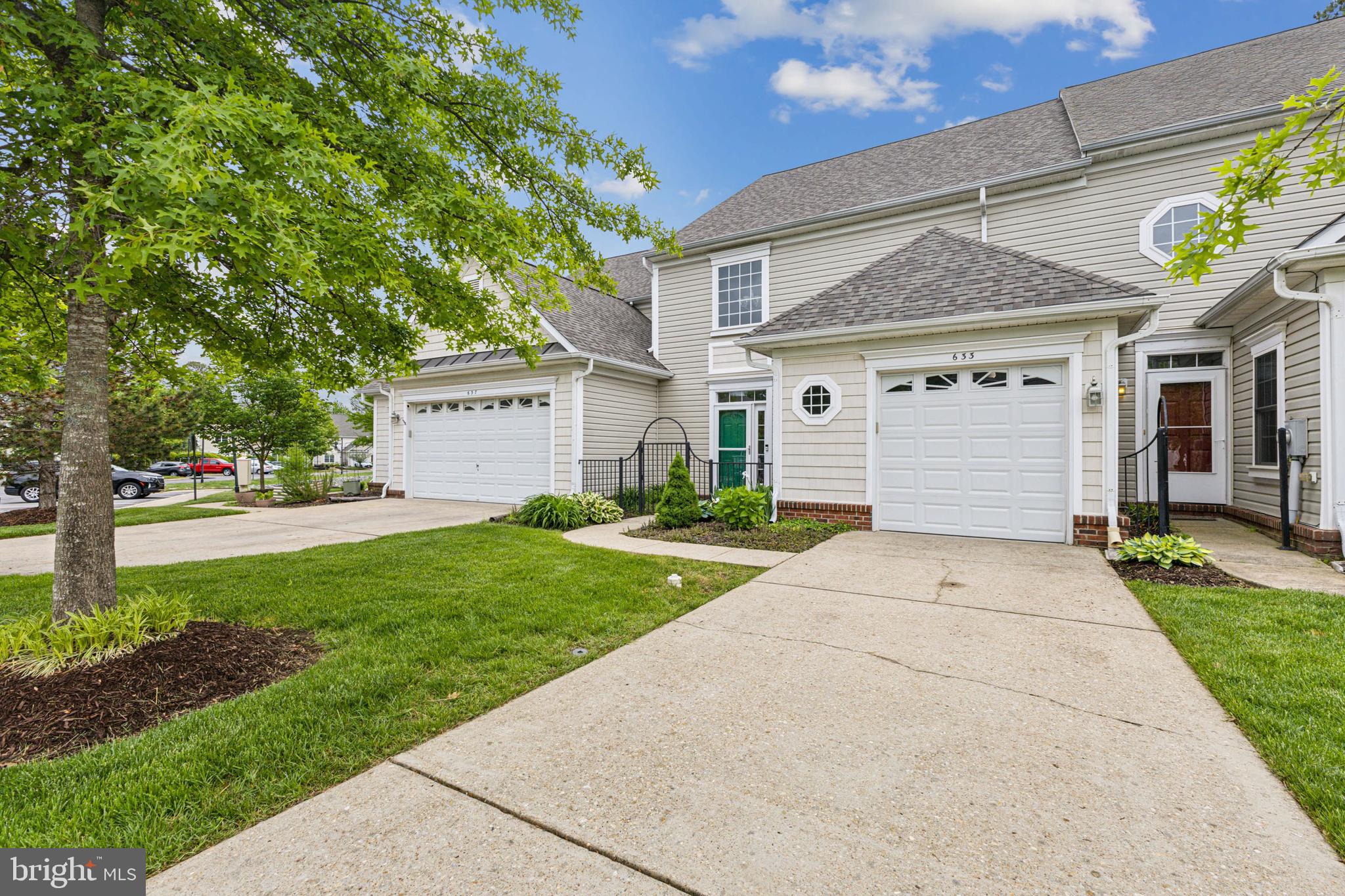 633 Ruxton Road, Unit 75 Solomons, MD 20629 - Photo 42 of 43 a front view of a house with a yard and a garage