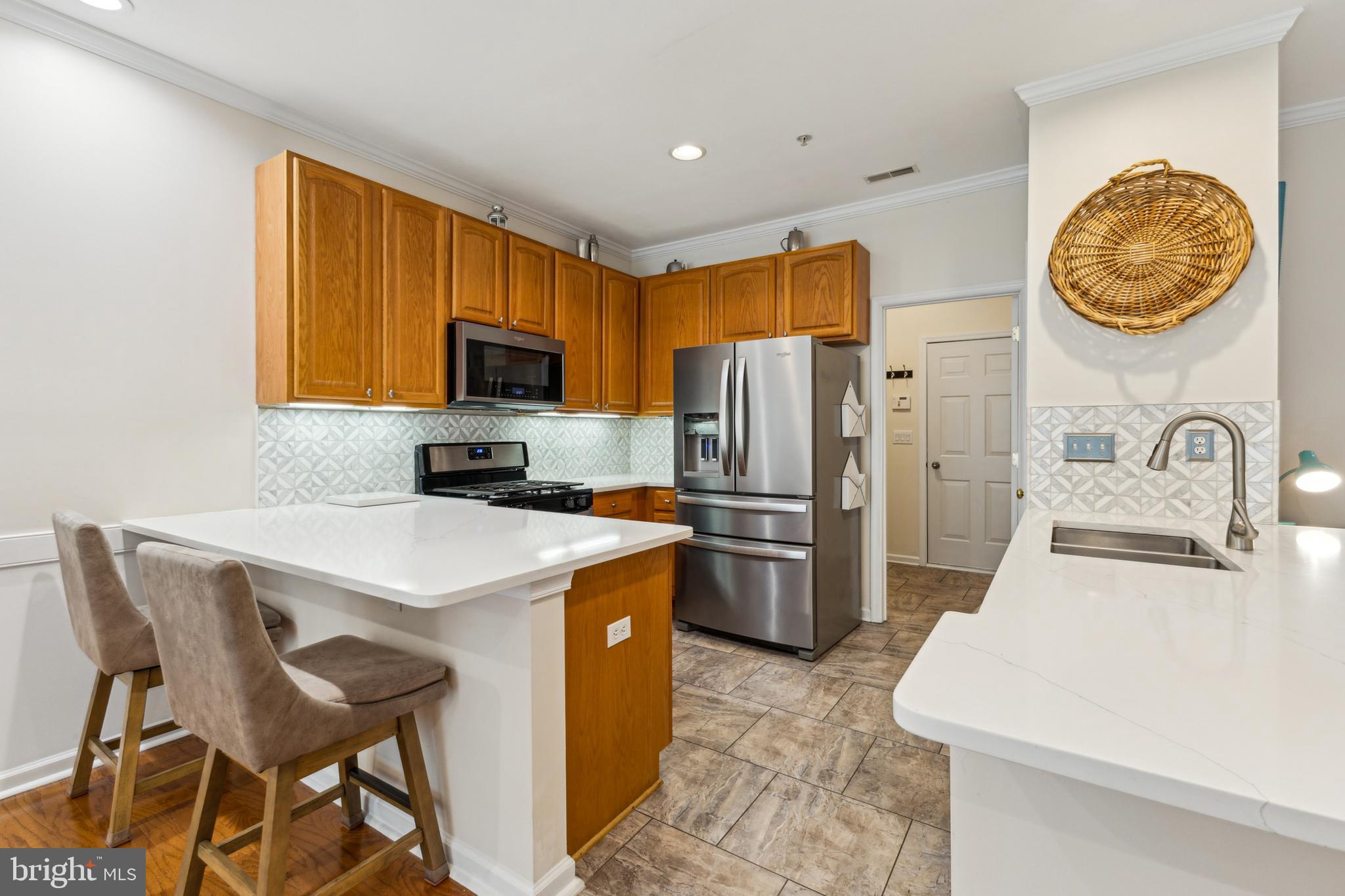 633 Ruxton Road, Unit 75 Solomons, MD 20629 - Photo 5 of 43 a kitchen with stainless steel appliances a stove a sink a microwave a refrigerator and a refrigerator