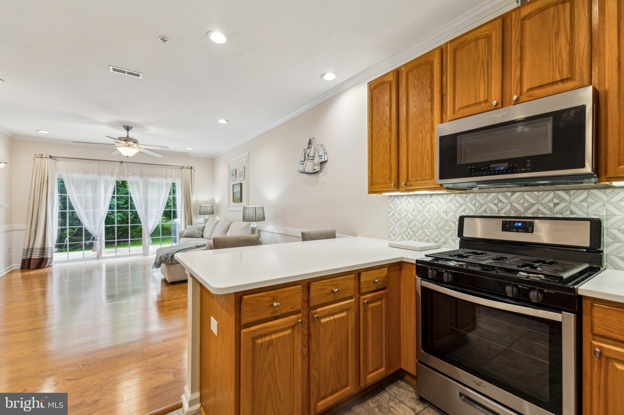 633 Ruxton Road, Unit 75 Solomons, MD 20629 - Photo 6 of 43 a kitchen with a stove microwave and sink