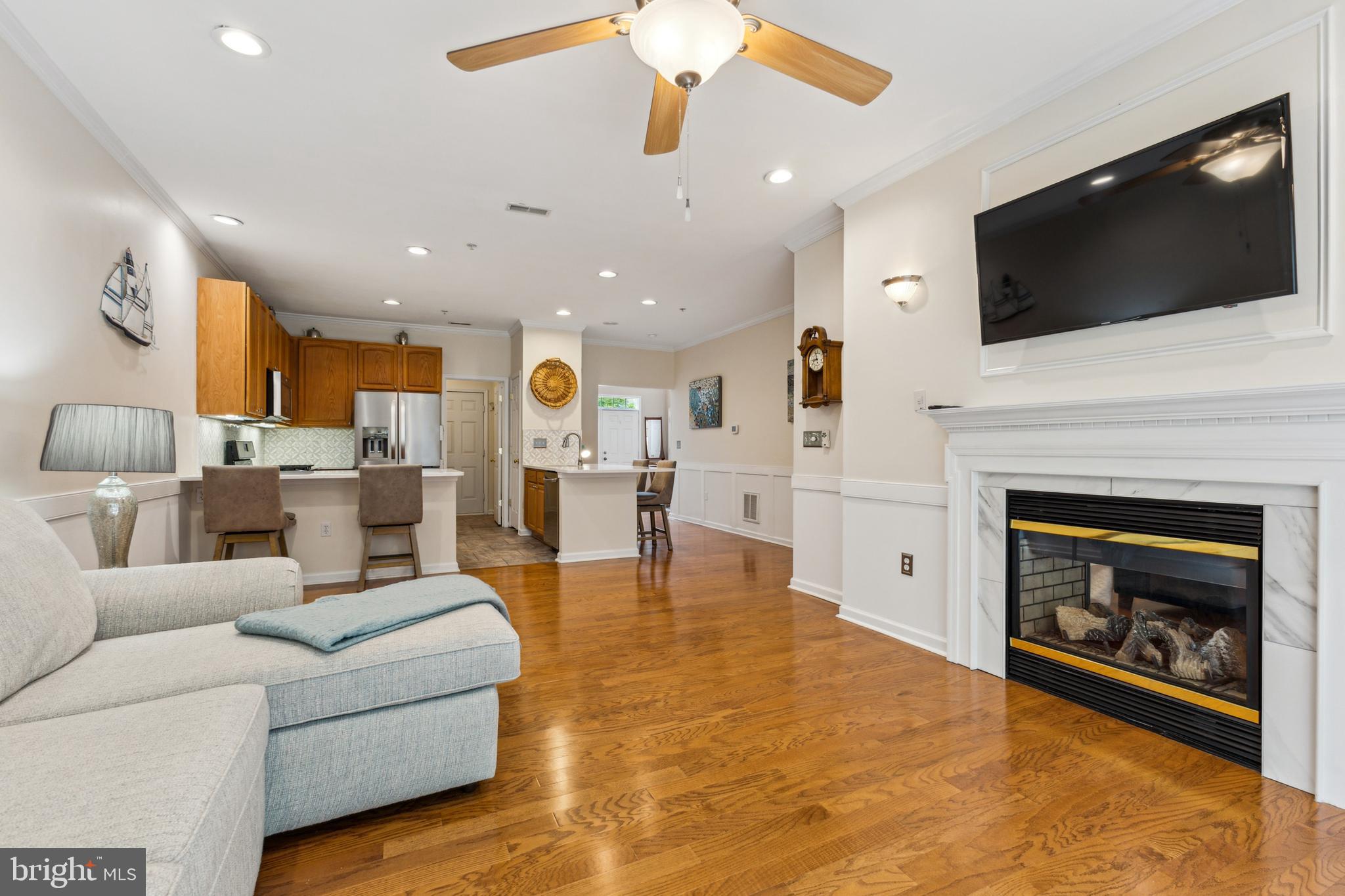 633 Ruxton Road, Unit 75 Solomons, MD 20629 - Photo 10 of 43 a living room with a fireplace and a flat screen tv