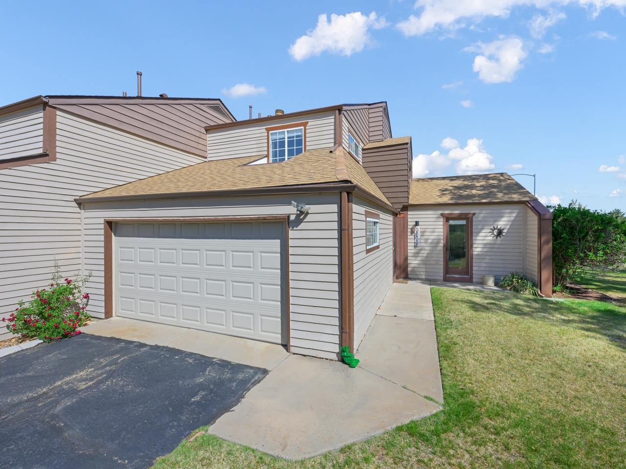 383 Explorer Court, Unit B Grand Junction, CO 81507 - Photo 3 of 40 a front view of a house with a yard and garage