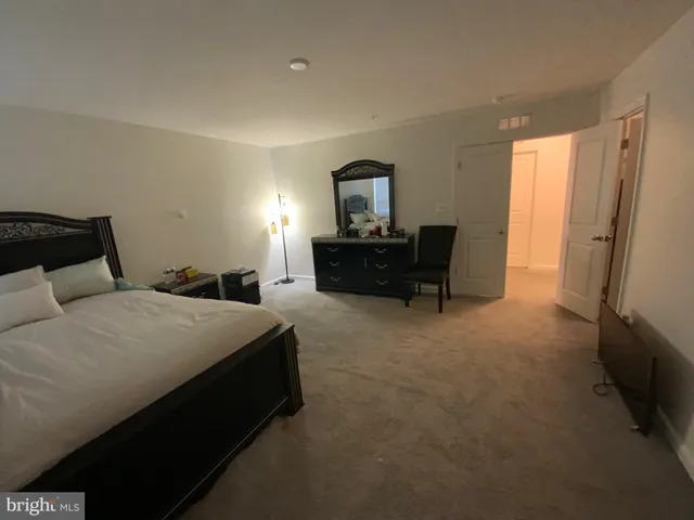 a bedroom with a bed and a television