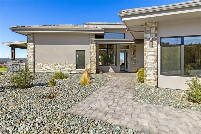 a living room with furniture a large window and a fireplace