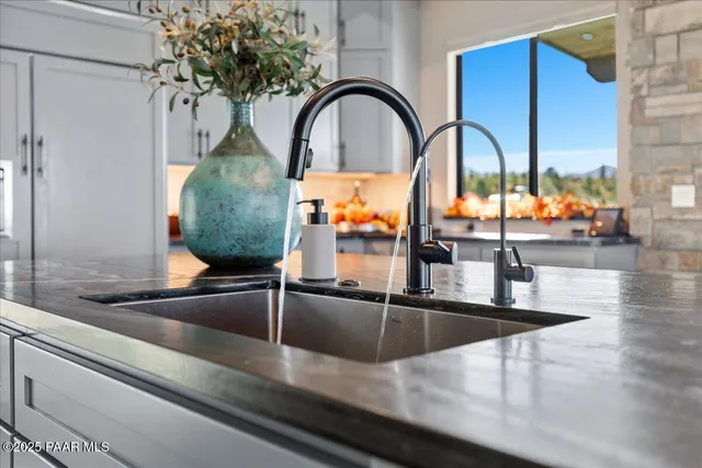 a bathroom with a granite countertop toilet sink mirror and vanity