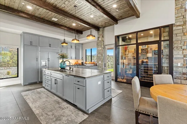 a living room with furniture a flat screen tv and a floor to ceiling window