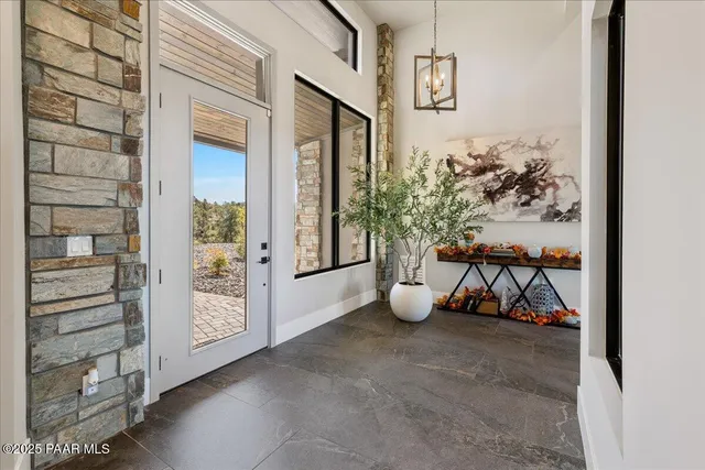 a living room with patio furniture and a potted plant