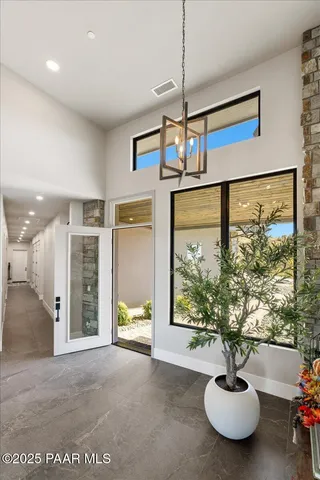 a living room with fireplace furniture and a large window
