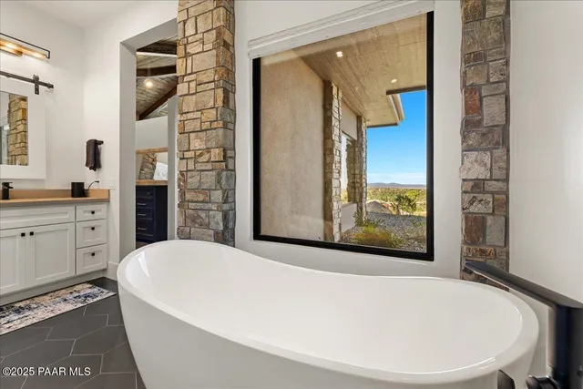 a living room with furniture a fireplace and a potted plant