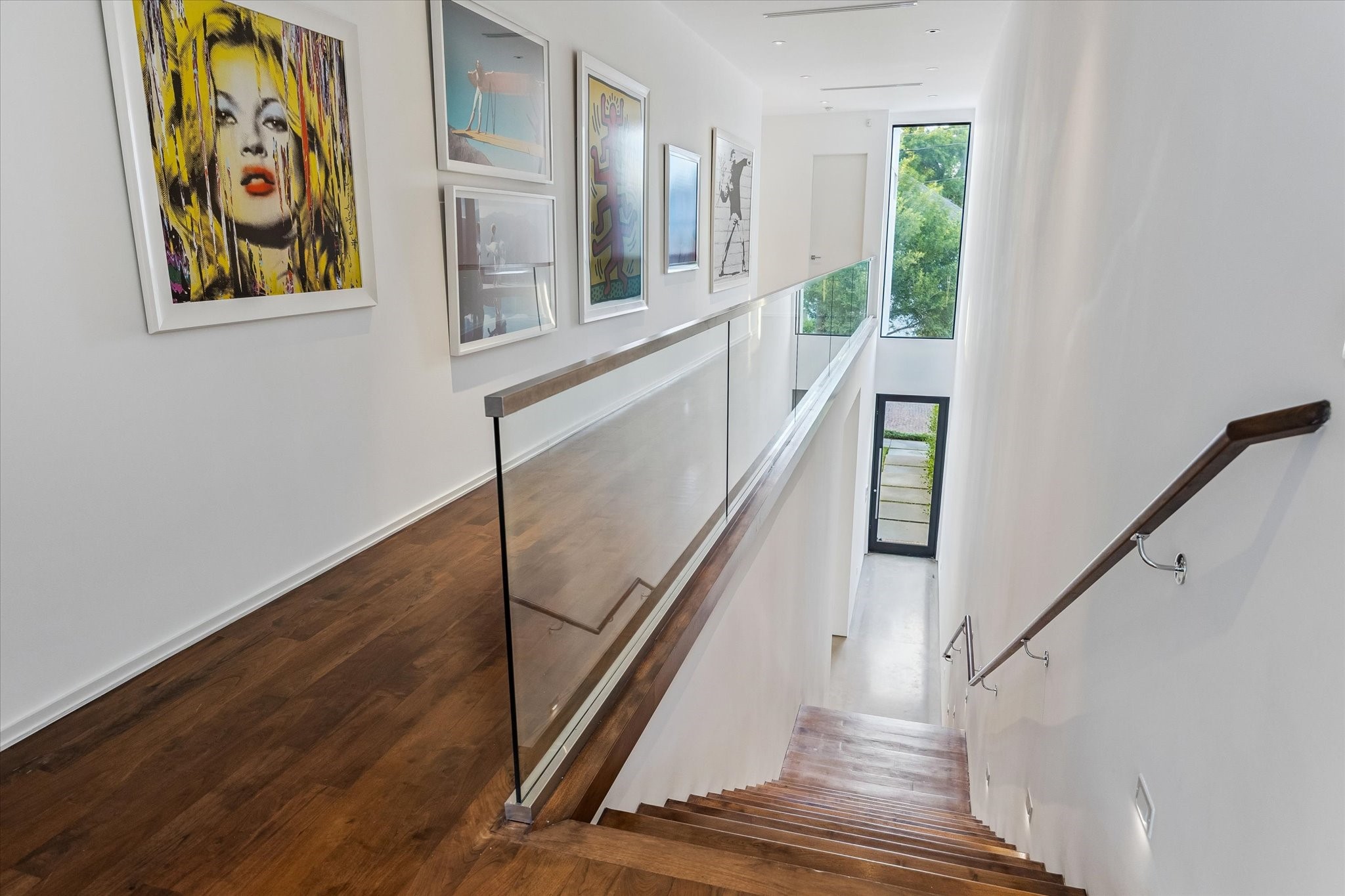 1527 Indiana Street Houston, TX 77006 - Photo 26 of 30 Floating steel stairs with wood trim. Beautiful 7" European wood floors.