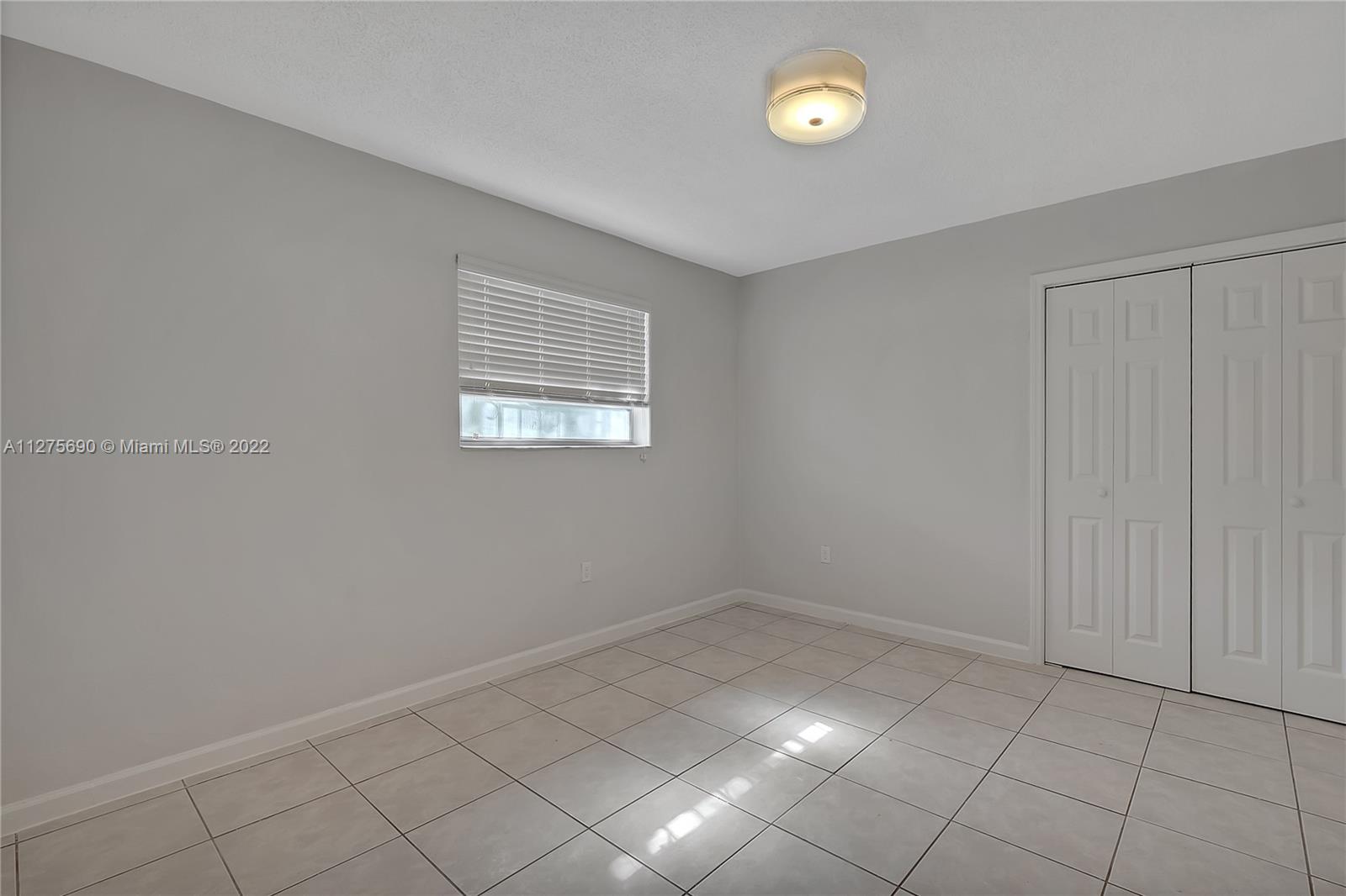 Allapattah Miami, FL 33142 - Photo 20 of 31 wooden floor in an empty room with a window