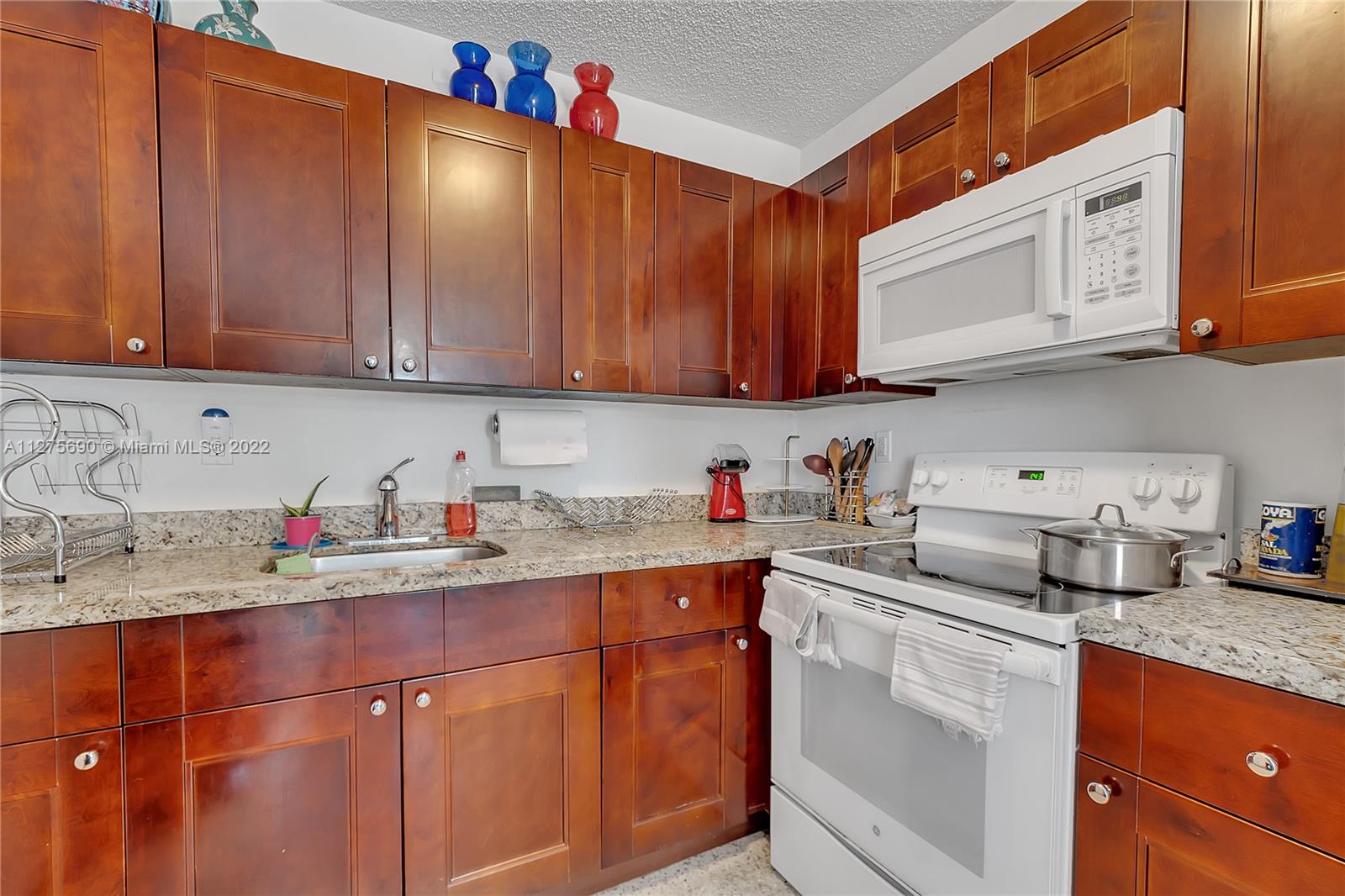 Allapattah Miami, FL 33142 - Photo 6 of 31 a kitchen with stainless steel appliances granite countertop a sink dishwasher stove and cabinets