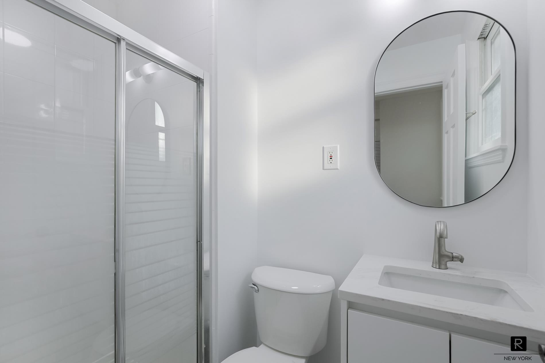 407 East 12th Street, Unit 4FSW Manhattan, NY 10009 - Photo 14 of 16 a bathroom with a toilet sink and mirror