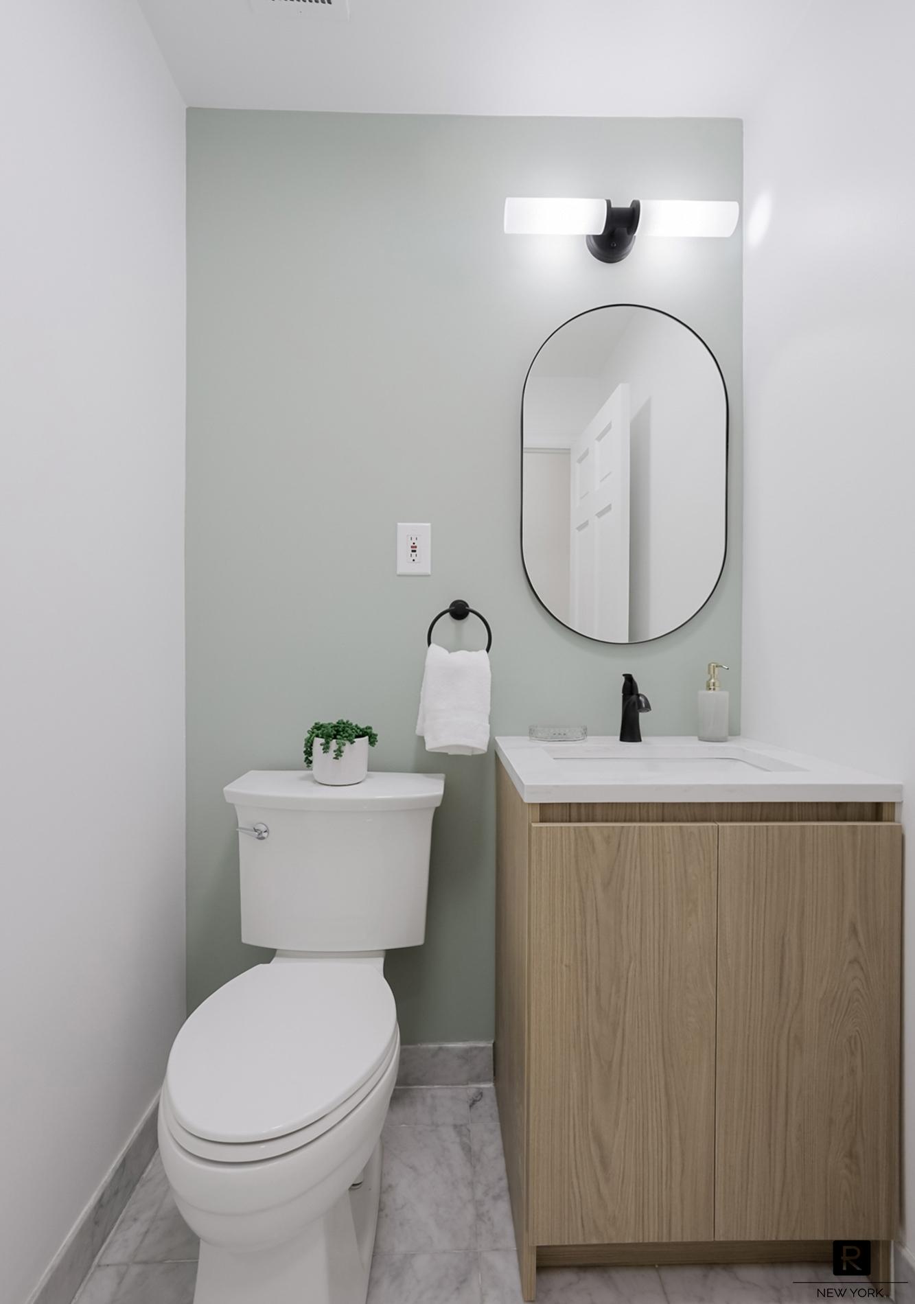 407 East 12th Street, Unit 4FSW Manhattan, NY 10009 - Photo 6 of 16 a bathroom with a toilet a sink and mirror
