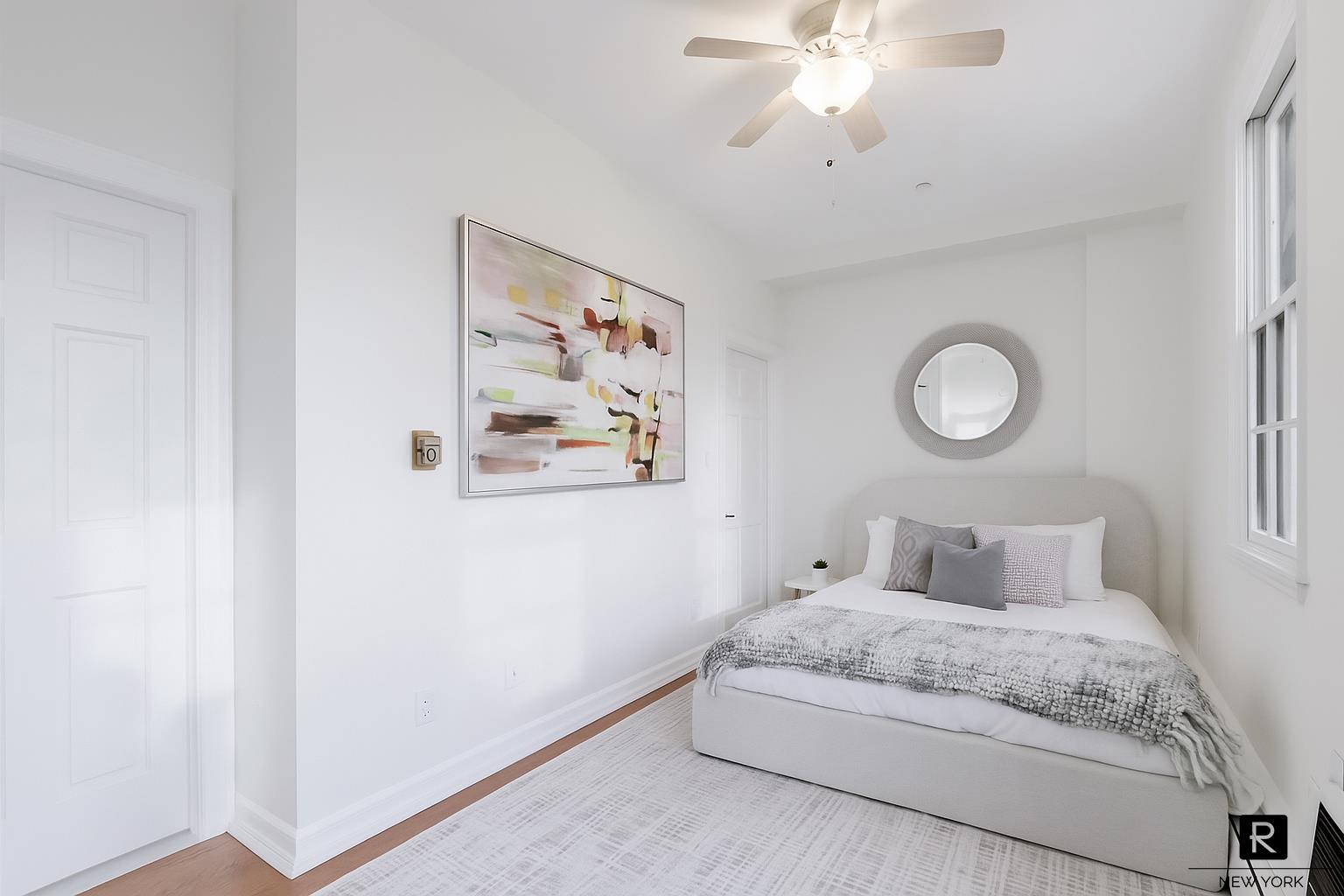 407 East 12th Street, Unit 4FSW Manhattan, NY 10009 - Photo 9 of 16 a bedroom with a large bed and a chandelier