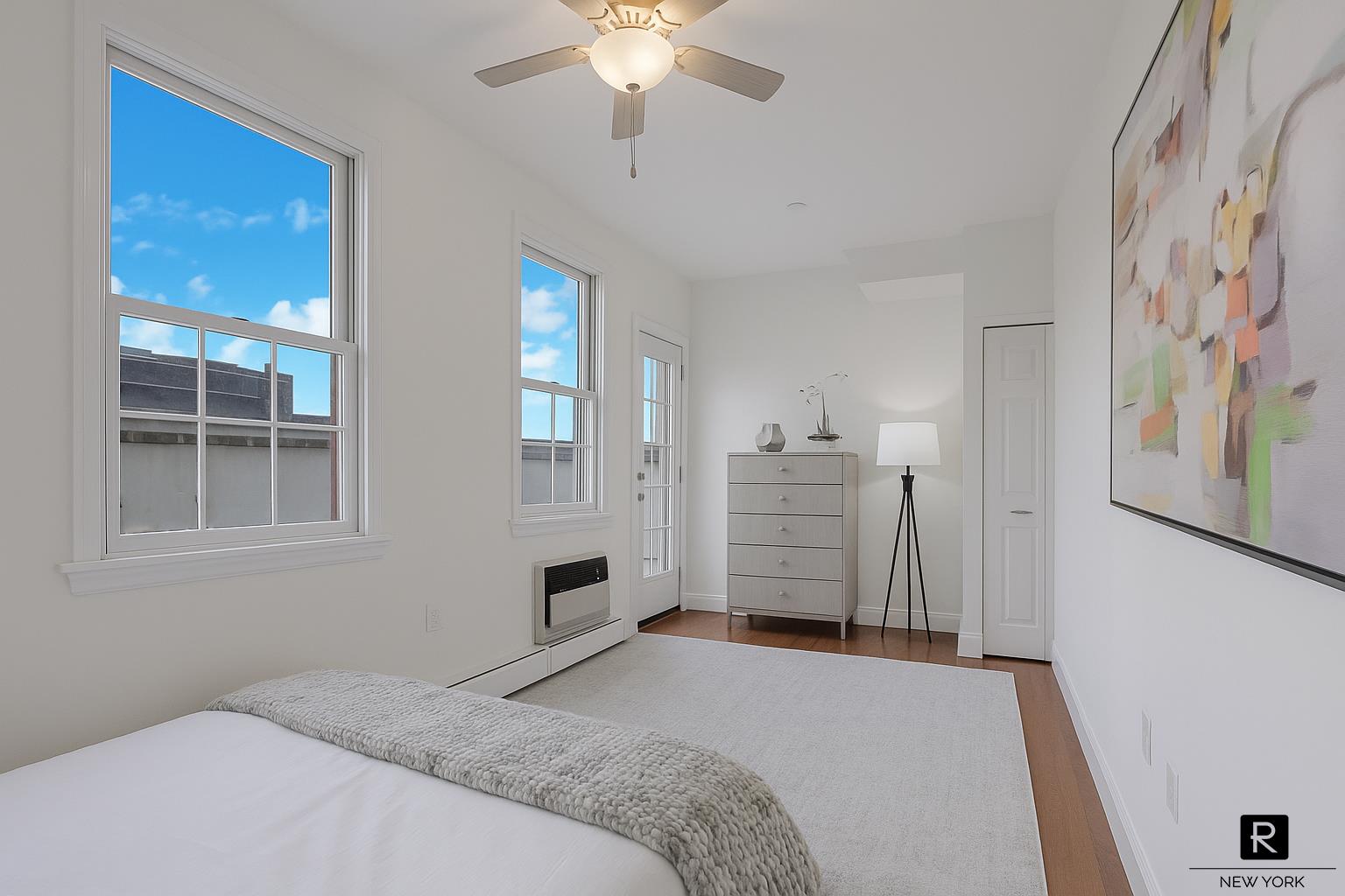 407 East 12th Street, Unit 4FSW Manhattan, NY 10009 - Photo 10 of 16 a bedroom with a bed and a chandelier