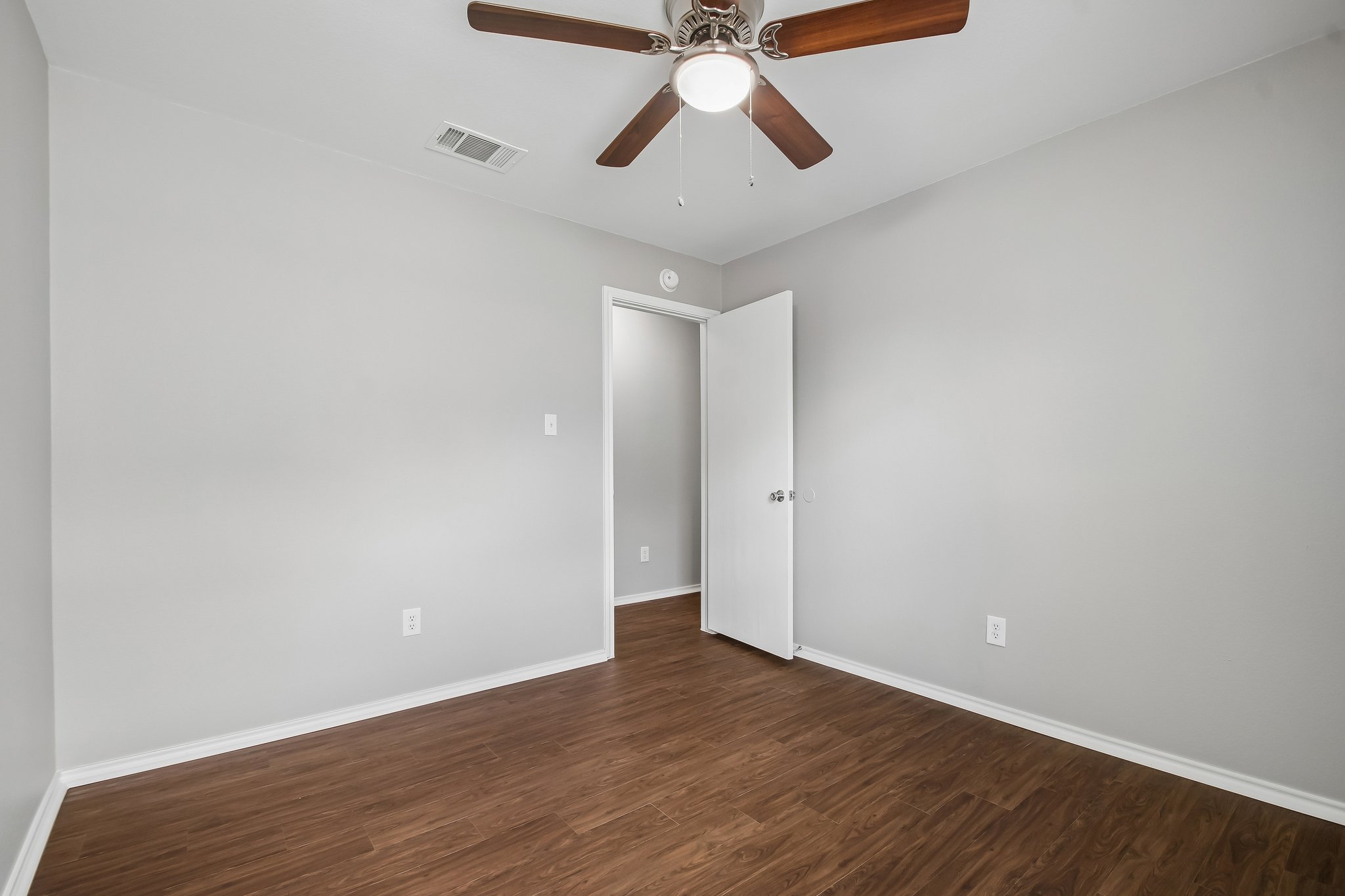 610 Lavaca Loop Elgin, TX 78621 - Photo 26 of 37 Hardwood floors and a ceiling fan create a comfortable atmosphere in this inviting room.