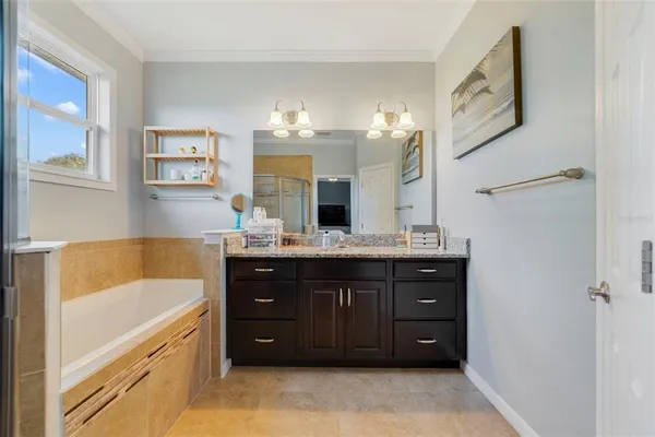 a bathroom with a tub sink and mirror