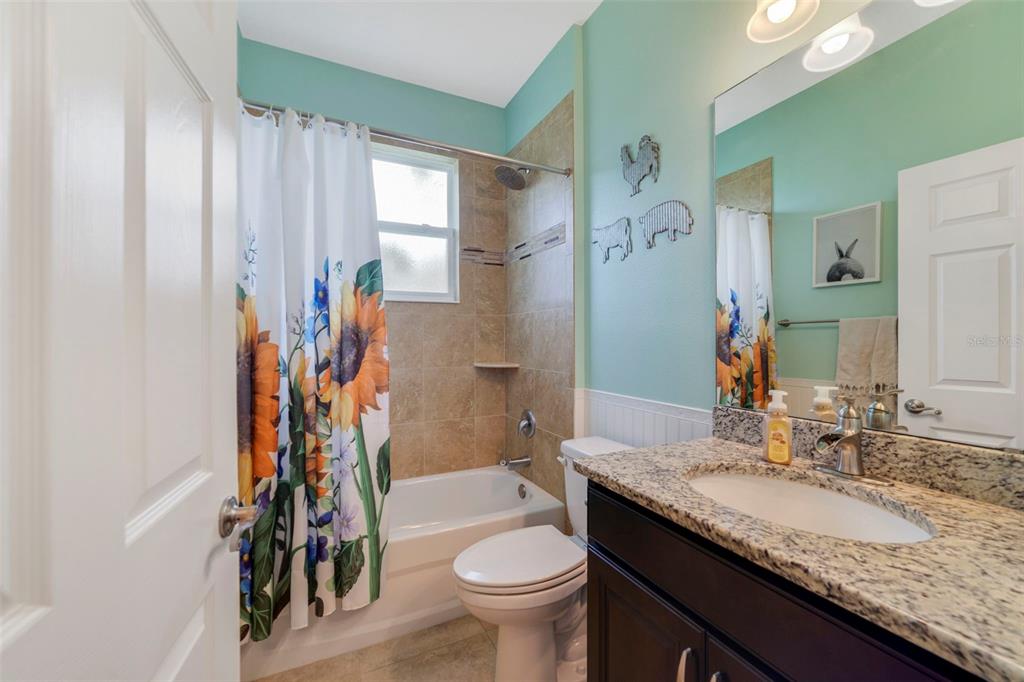 37041 North Thrill Hill Road Eustis, FL 32736 - Photo 16 of 25 a bathroom with a granite countertop sink toilet and shower