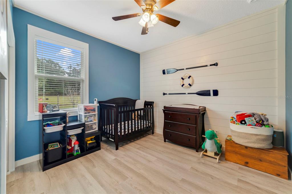 37041 North Thrill Hill Road Eustis, FL 32736 - Photo 17 of 25 a bedroom with furniture and a window